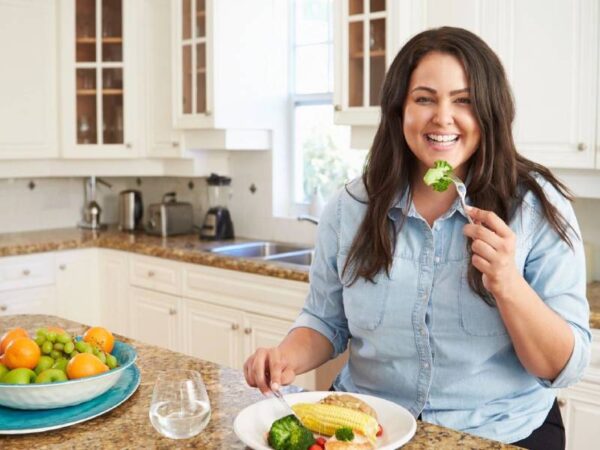 A woman sitting at the table eating food.